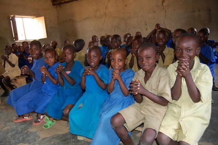 Rwandan schoolchildren excited to receive their deworming medication.  Photo courtesy of The Access Project